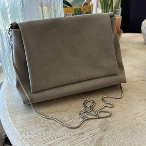Like new grey with silver coiled strap hand bag.